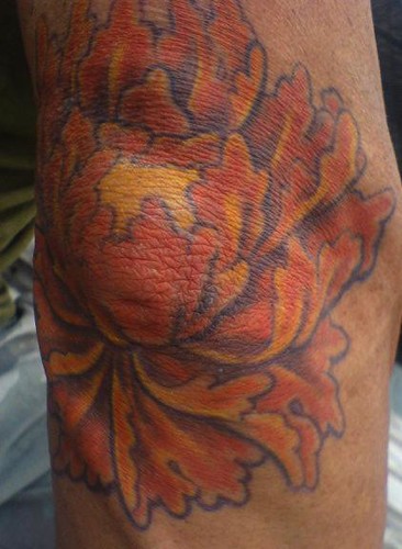 flower on elbow tattoo by thomas jacobson