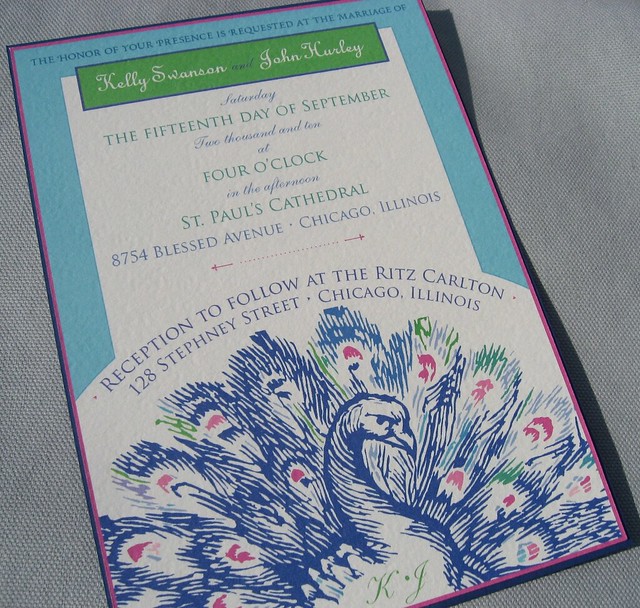 I knowa brilliantly colored peacock on a handmade wedding invitation