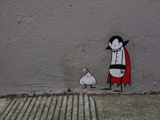 Graffito of a cartoon vampire looking at garlic