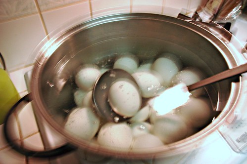 Happy Easter, Boiling eggs in a pot with ladle in water, San Mateo, California, USA by Wonderlane