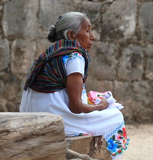 Sweet ancient Mayan vendor waiting for tourist to pass near her