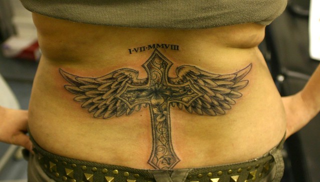 cross with wings and flowers cover up tattoo