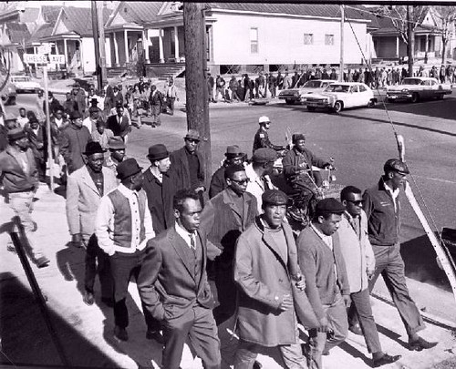 African American sanitation workers and their community supporters march through the streets of Memphis in 1968. by Pan-African News Wire File Photos