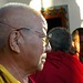 Face of an older lama / monk, meditator, wearing a rosewood mala, and glasses, Tharlam Monastery, Boudha, Kathmandu, Nepal