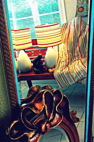 Reflection lamps, statue of young Buddha, mirrors, blanket, Tibetan silk, wood bench, tile floor, San Mateo, California, USA by Wonderlane
