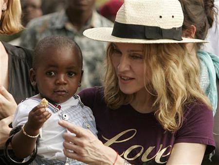 American recording artist Madonna holds her adopted son, David Banda, in Mphendula, Malawi on April 19, 2007. She has now adopted a girl from the same country. by Pan-African News Wire File Photos