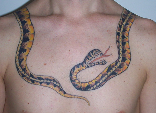 old school snake tattoo around neck and shoulder by tattootrix