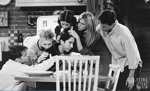 Black and white photo of the whole cast consoling Ross Jennifer Aniston 