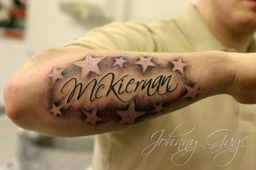 name with shaded stars tattoo on forearm Tattooed by Johnny at