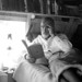 Old hermit Roy Ozmer reading a book at his house: Pelican Key, Florida
