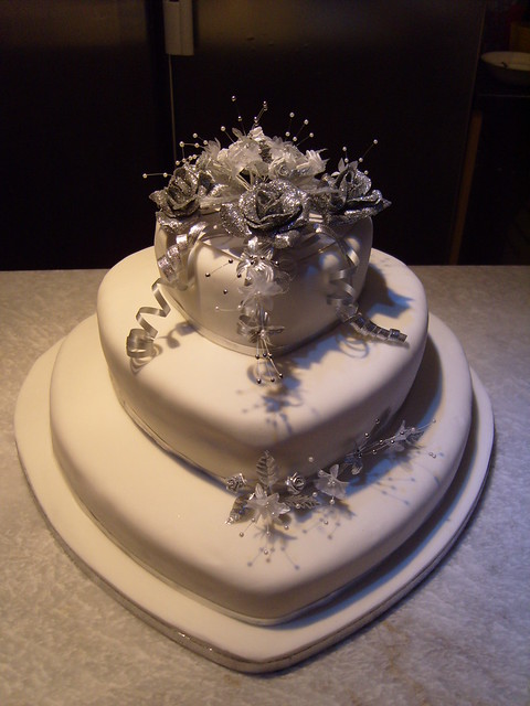 silver and white heart shaped wedding cake