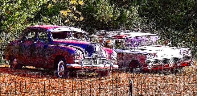 This is a view of a two rusty classic cars 1946 Kaiser Sedan and 1959 Ford 