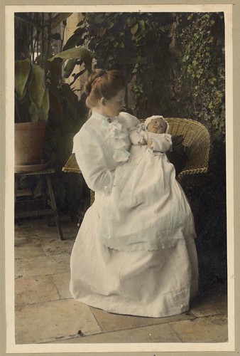 Vintage Portrait of a Mother holding a Baby Child on the Patio Outside