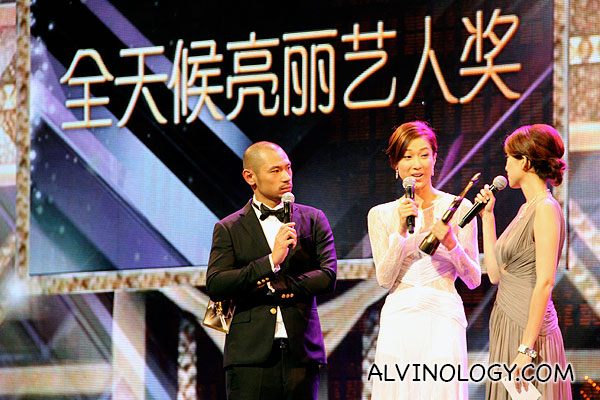 Linda Chung collecting an award on stage 