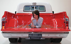 1968 GMC Photo Shoot Looking at the back of the truck the tailgate is down there is a girl in the back of the truck