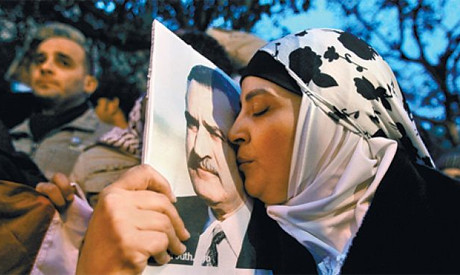 An Egyptian woman kissing a portrait of former President Gamal Abdel Nassar. He nationalized the Suez Canal and fought Israel, Britain and France. by Pan-African News Wire File Photos