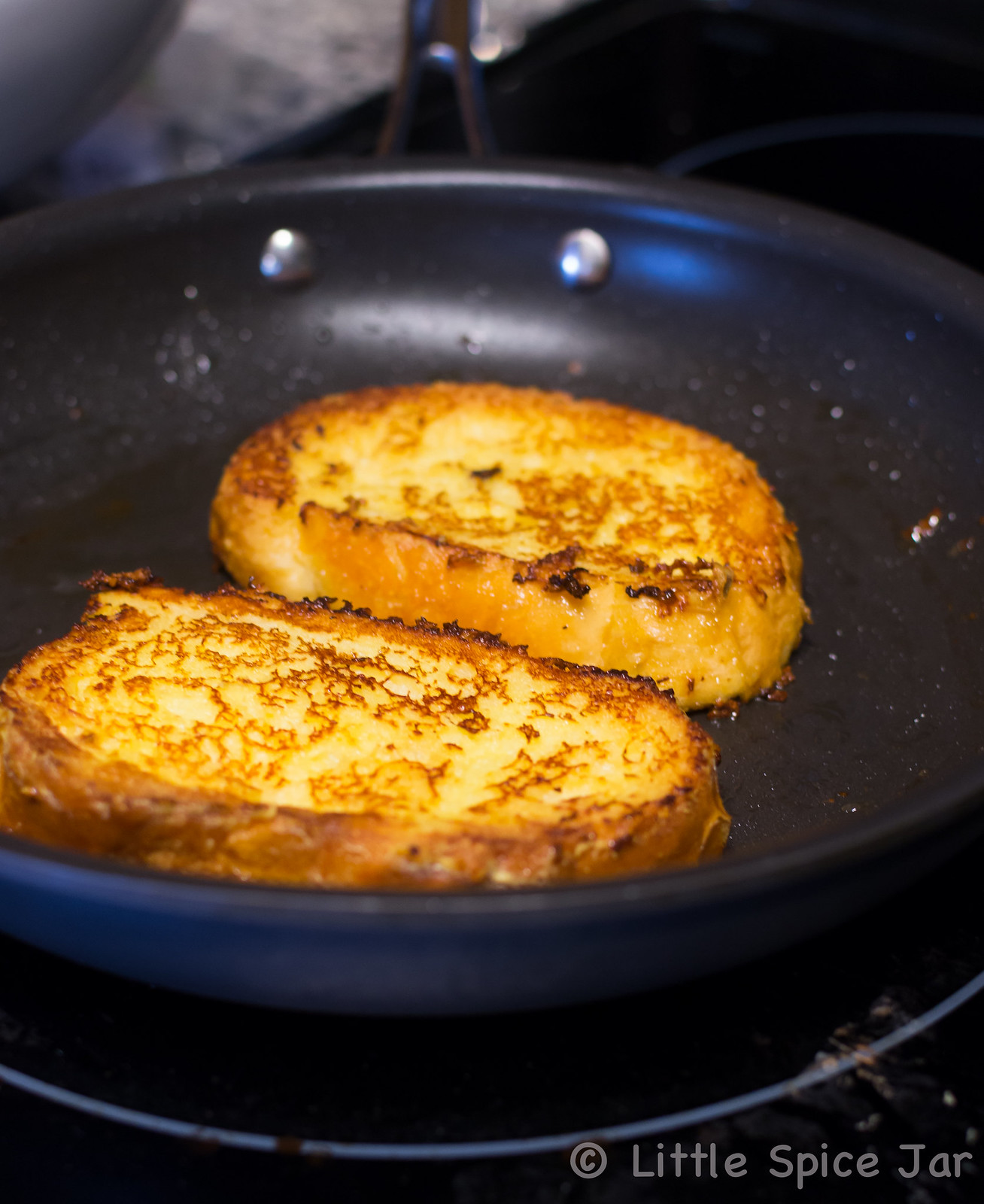 cooking French toast in black frying pan