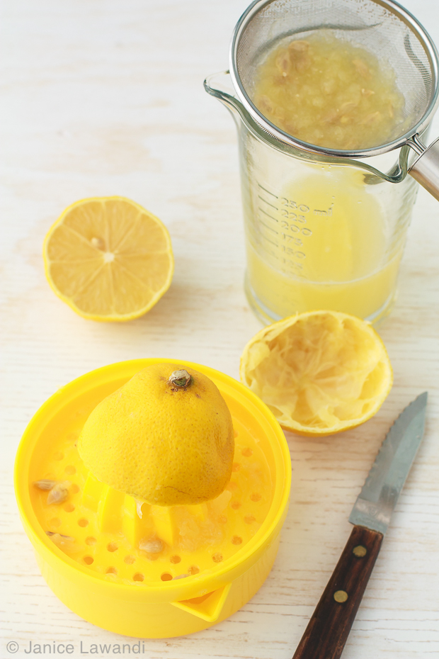 juicing a lemon by hand 