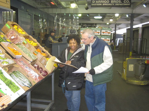 USDA Market News reporter Lynn Collins (left) from the Bronx, NY office gets prices from a sales rep at the fruit and vegetable terminal market.   For a few weeks in October when Market News reports weren’t available, there was a higher risk that producers – especially small farmers and ranchers – would over-pay or under-price their goods.