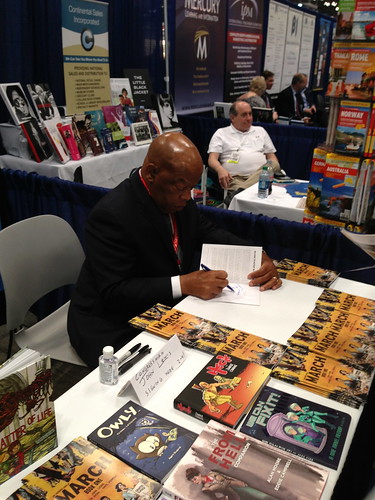 Congressman John Lewis signing a comic book, BEA 2013