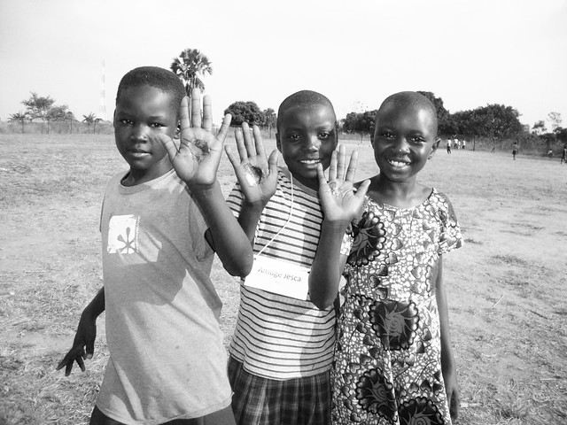 Ugandan kids holding homemade soap in the palm of their hands