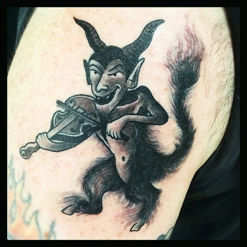 I got my #Halloween #tattoo by @robjunod at #HolyCityTattooingCollective in #Charleston #SC Check out that #Satyr fiddling the night away! I admire his goatee...