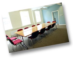 well lit room with boardroom layout for 12 people