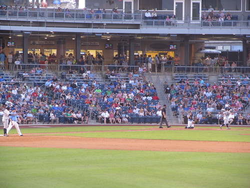 Batter and catcher blend into the crowd at ONEOK Field