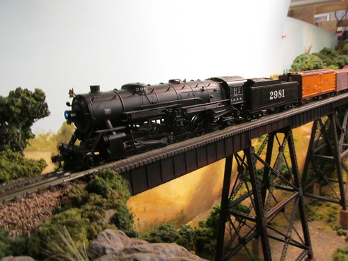 A steam powered Illinois Central Railroad freight train crossing the tall steel trestle.  The Oak Park Society of Model Engineers,H.O Scale Model Railroad Club.  Oak Park Illinois.  July 2013. by Eddie from Chicago