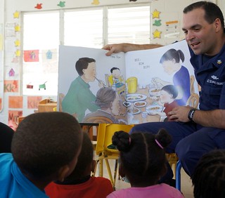 Petty Officer 2nd Class Daniel Jarrett, from the Resident Inspection Office Saint Croix, reads to children at the Community Methodist Head Start facility in Saint Croix, U.S. Virgin Islands Feb. 21, 2014. The read-in activity was part of the island’s Department of Human Services Head Start Program Black History Month celebrations. (U.S. Coast Guard photo by Coast Guard Auxiliarist Robert A. Fabich)