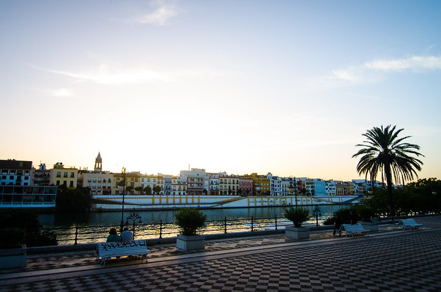 A lovely sunset view of colorful buildings and the Guadalquivir River in Sevilla.