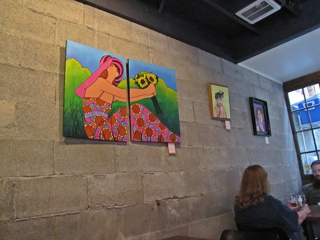 woman with hat on wall at Populuxe