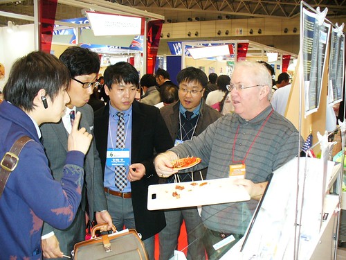 Michael Scott of Maniilaq Services, a non-profit that represents federally-recognized tribes in Northwest Alaska, serves samples of smoked salmon to buyers at Japan’s international food and beverage show called FOODEX earlier this year. The Foreign Agricultural Service partners with the Intertribal Agriculture Council to help nearly 70 Indian-owned businesses and organizations export their products.  (Courtesy Photo)