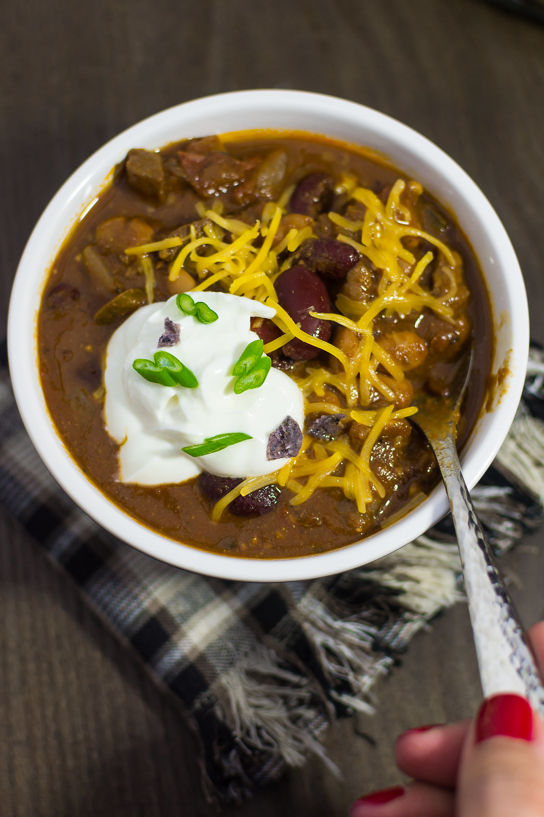 Smoky Homestyle Chili Final Close up with Hand_