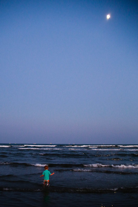 Toddler Wading in the Ocean with the Moon