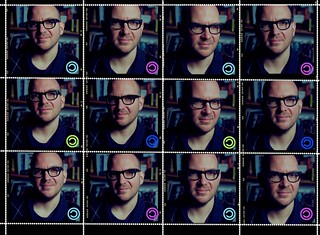 Twelve headshots of Cory Doctorow made to look like postage stamps