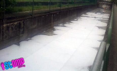 Sudsy deposits turn water in Sungei Kallang drain white