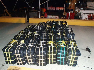 Twenty-five bales of cocaine weighing 2,546 pounds and with an estimated wholesale value of $34 million dollars rest on a boat pier in Ponce, Puerto Rico, Oct. 18, 2013, following the Coast Guard Cutter Drummond's offload of the contraband and transfer of three apprehended drug smugglers to Customs and Border Protection officers, Immigrations and Customs Enforcement (ICE)-Homeland Security Investigations, and Drug Enforcement Administration special agents in Ponce, Puerto Rico.  The drug shipment and apprehended smugglers resulted from an interagency at-sea interdiction Oct. 18, 2013, south of St. Croix, U.S. Virgin Islands.