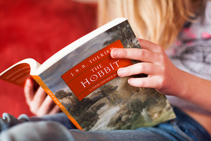 A little girl reading the Hobbit