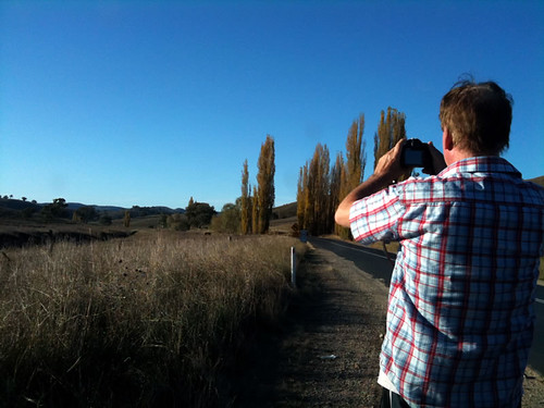 Mike is taking a photo of the landscape.
