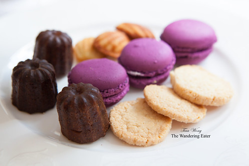 From the dessert tiers (Petit Four collection): Mini canelés, blueberry macarons, madelines, and butter shortbread cookies