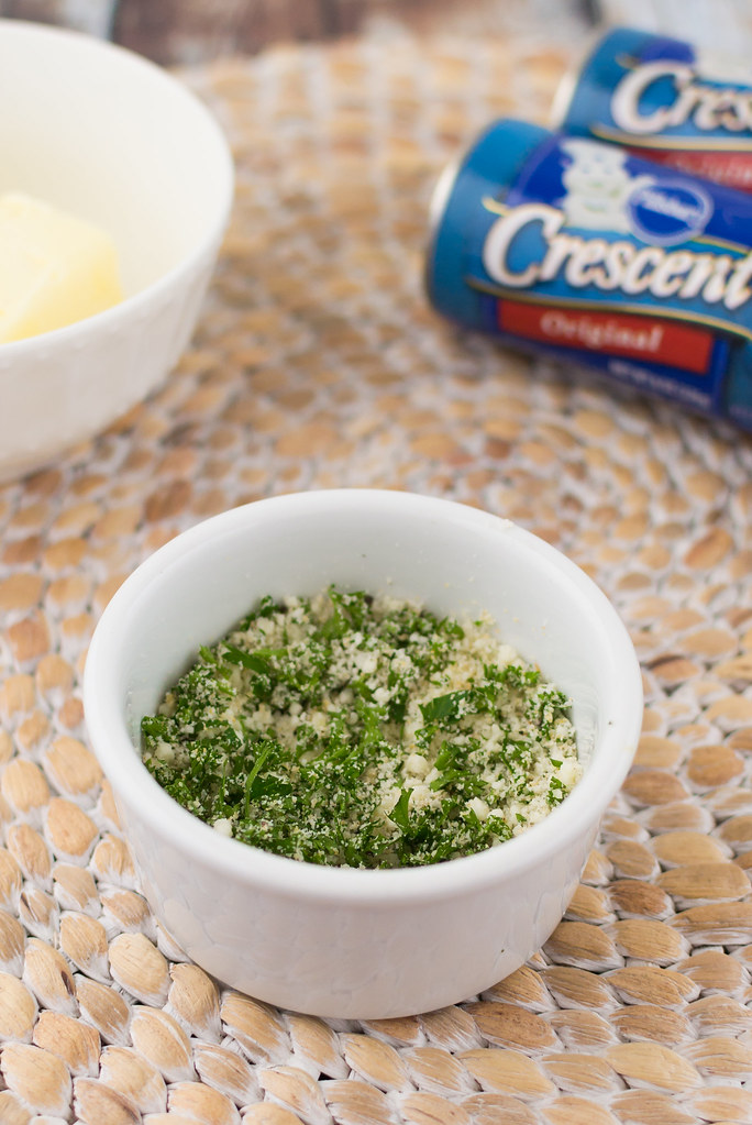 Small white bowl filled with parsley, parmesan, garlic and cracked pepper