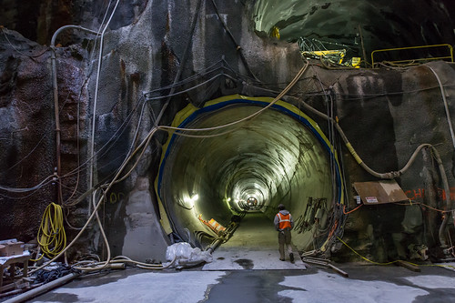 Including a MTA employee helps to show the scale of the subway tunnel.