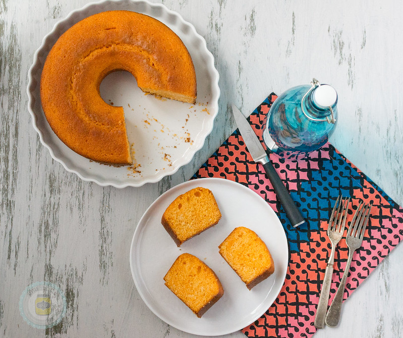 Moroccan-Orange-Cake-Three-Slices on a white plate and the rest of the cake with slices missing also on a white platter