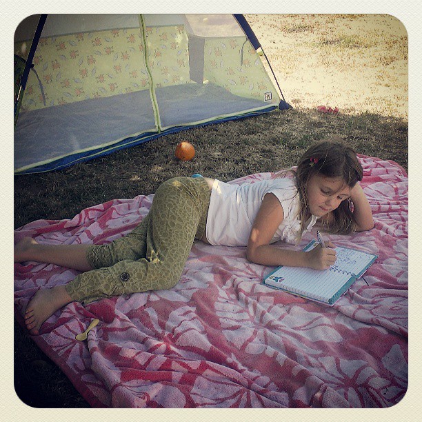 Writing all her summer dreams in her journal...