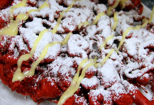 Cream-cheese drizzle on our Red Velvet Funnel Cake