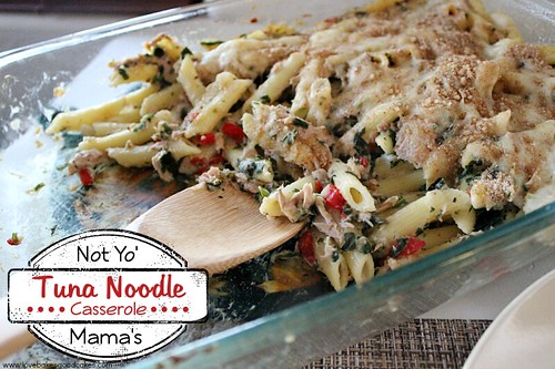 Not Yo' Mama's Tuna Noodle Casserole in clear casserole dish with wooden spoon.