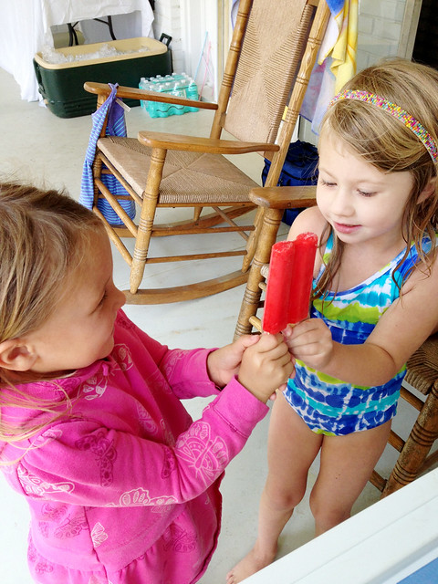 sassy and ella sharing a popsicle