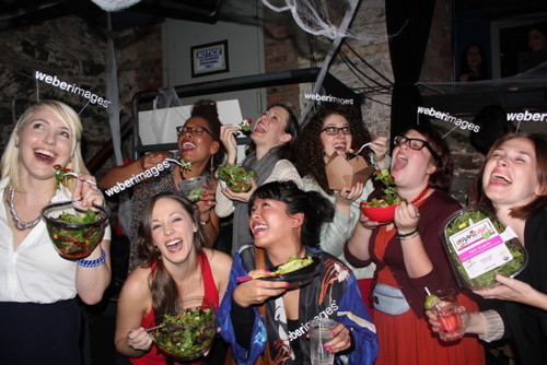 Women laughing alone with salad Halloween costume