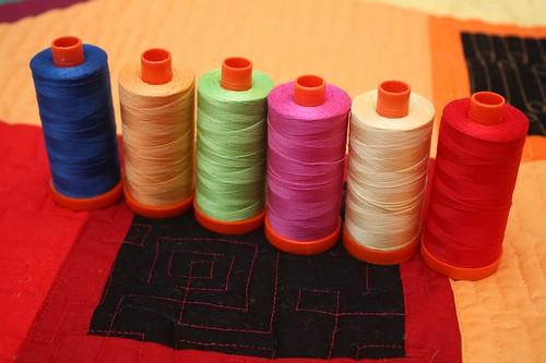 The line-up - Aurifil (all 50 wts) from L-R -  navy (#2735), orange (#2214), green (#5017), fuchsia (#2588), yellow (#2105), and red (#2250)